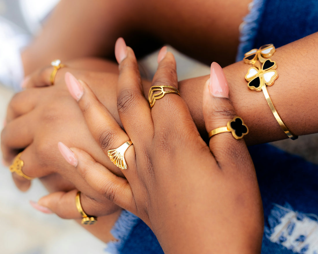 Hands adorned with gold jewelry