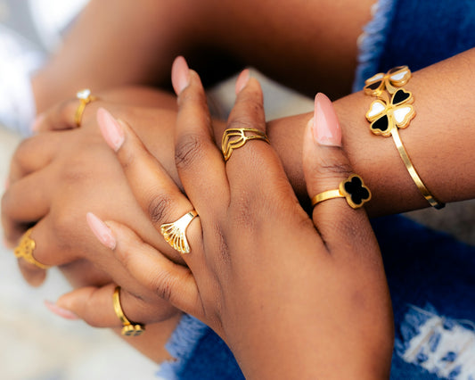 Hands adorned with gold jewelry